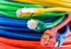 Colorful network cables with various connectors arranged in a pile