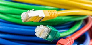 Colorful network cables with various connectors arranged in a pile
