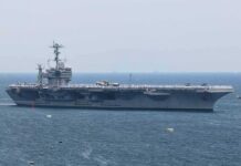 Navy’s Big Drone Promise Slips to 2029 Aircraft carrier sailing at sea