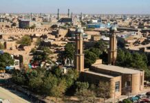 Blast Damage Reported at Historic Iranian Sites Aerial view of a city featuring traditional buildings and minarets