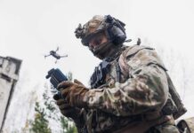 soldier operating a drone with a handheld controller