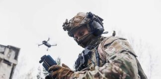 soldier operating a drone with a handheld controller
