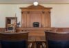 Life Sentence Marks Major Victory Judge's bench in a traditional courtroom with wooden paneling and empty seats