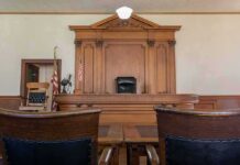 Life Sentence Marks Major Victory Judge's bench in a traditional courtroom with wooden paneling and empty seats