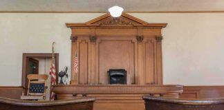 Life Sentence Marks Major Victory Judge's bench in a traditional courtroom with wooden paneling and empty seats