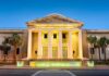 Federal Agent Charged After Brutal Hazing Supreme Court building with illuminated columns at dusk