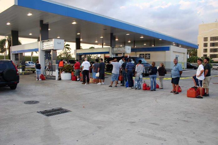 People,With,Empty,Containers,Waiting,In,Line,To,Buy,Gasoline. People waiting in line at a gas station with fuel containers