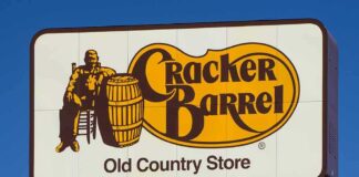 Cracker Barrel roadside sign with logo against blue sky