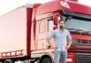 man standing in front of a red semi truck
