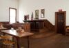 Final Appeal Denied: Trump Now Faces $5.8 Million Payment Interior of a historic courtroom with wooden furniture and an American flag