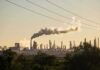 Russia’s Energy Edge Takes a Major Hit Industrial refinery with smokestack emitting plume at sunset