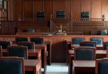 Pink Wave Bets On Accused Child Killer Empty courtroom with wooden benches and judge's bench