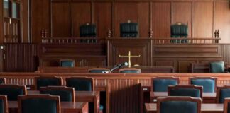 Empty courtroom with wooden benches and judge's bench