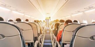 Mysterious Odor Forces Frontier Flight to Divert airplane cabin with passengers seated in economy class