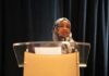 Legal Wall: Trump Claims Immigration Action Woman in hijab speaking at a podium