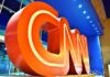 Large red CNN logo sculpture at building entrance