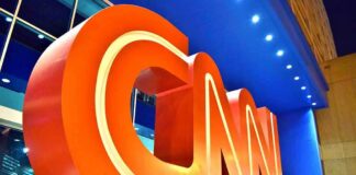 CNN Airs Wrong Photo in Dolly Parton Tribute Large red CNN logo sculpture at building entrance