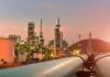 Oil refinery with pipelines at sunset