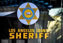 Federal Sentence in Violent LA Protest Case Los Angeles County Sheriff emblem on a glass door