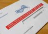 Late Ballots Crush Spencer Pratt’s Runoff Hopes Mail-in ballot envelope with red label on wooden table