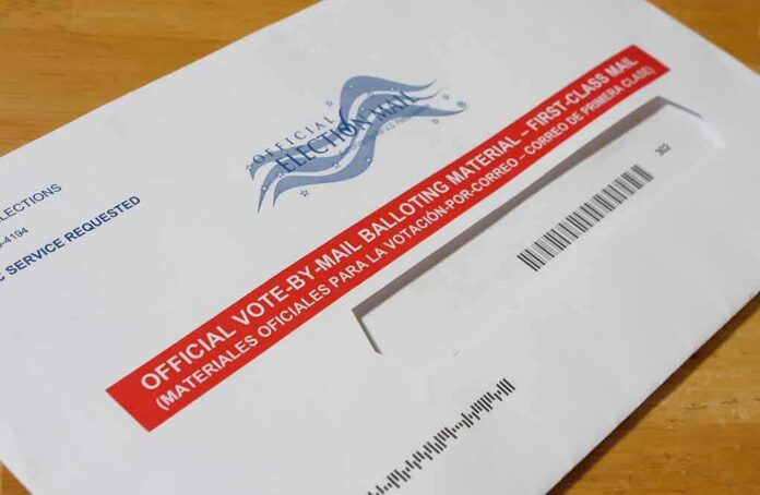 shutterstock_1787423186 Mail-in ballot envelope with red label on wooden table
