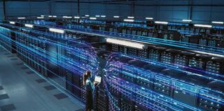 Meta Tests Robots for Data Center Operations Technician with laptop in a large data center aisle
