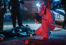 False Online Claim Fuels Brutal Killing forensic investigator photographs crime scene evidence at night