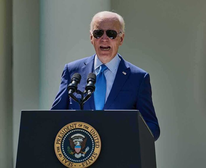 shutterstock_2299761835-1 man in blue suit speaking at a podium with presidential seal