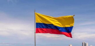 Trump-Backed Hardliner Wins Colombia in Stunning Photo Finish Colombian flag waving over a coastal city skyline