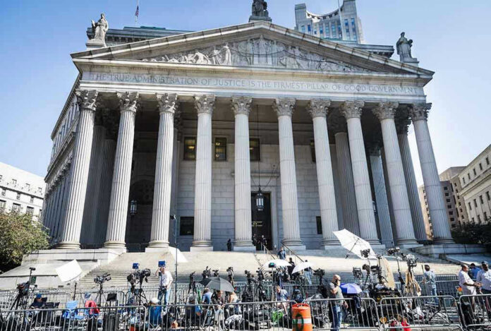 Teddy Williams at courthouse steps with media outside a neoclassical building