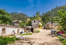 Haiti Church Attack Leaves Dozens Dead Rural village street with people gathered and hills in the background