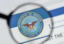 magnifying glass focusing on U.S. Department of Defense seal