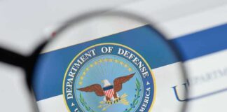 magnifying glass focusing on U.S. Department of Defense seal