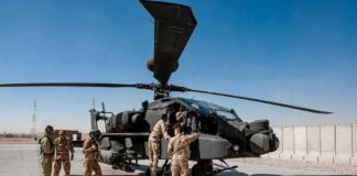 Satellite Data Tied to Deadly Iran Strike Soldiers inspect a military attack helicopter on a tarmac