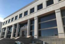 Modern office building with columns and reflective windows
