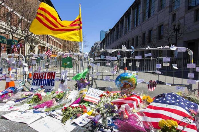 shutterstock_140531467 Memorial with flowers and flags by street barricades