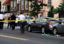 Deadly Manhunt Ends After Police Pursuit Police at urban street crime scene with yellow tape around parked cars