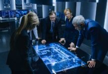 Poland Warns of Russian “Hybrid” Attacks Business team reviewing digital map on illuminated table