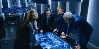 Poland Warns of Russian “Hybrid” Attacks Business team reviewing digital map on illuminated table