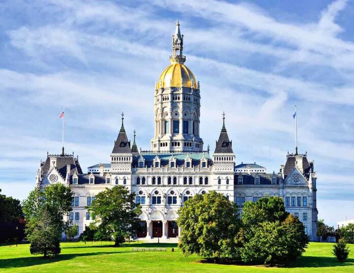 Connecticut State Capitol building with a golden dome and surrounding greenery