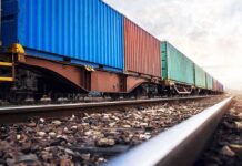 Freight train with colorful shipping containers on railway tracks