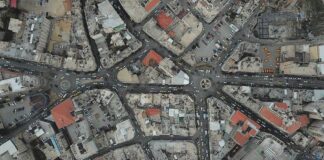 Aerial view of multi-road urban intersection with dense buildings