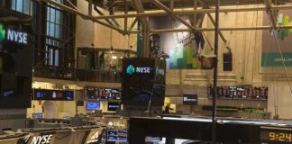 NYSE trading floor with monitors and tickers