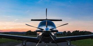 Single-engine propeller airplane on runway at sunset