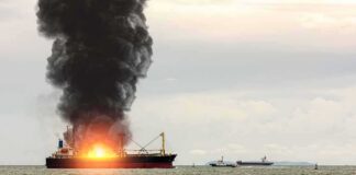 Pentagon vs Tehran: Dueling Tanker Stories Cargo ship on fire with thick black smoke at sea