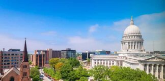 Capitol building with dome overlooking a city park