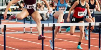 3-Medal Claim Fuels Women’s Sports Debate Female athletes clearing hurdles on a track