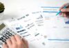 New York Expands Utility Bill Discounts Hands reviewing utility bills with calculator and pen
