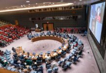 NATO-Russia Tensions Move Closer to the Edge Delegates seated around a circular conference table in a large chamber