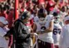 Coach Links Trump Exit to Comms Failure Mississippi State football coach and quarterback review play card on sideline